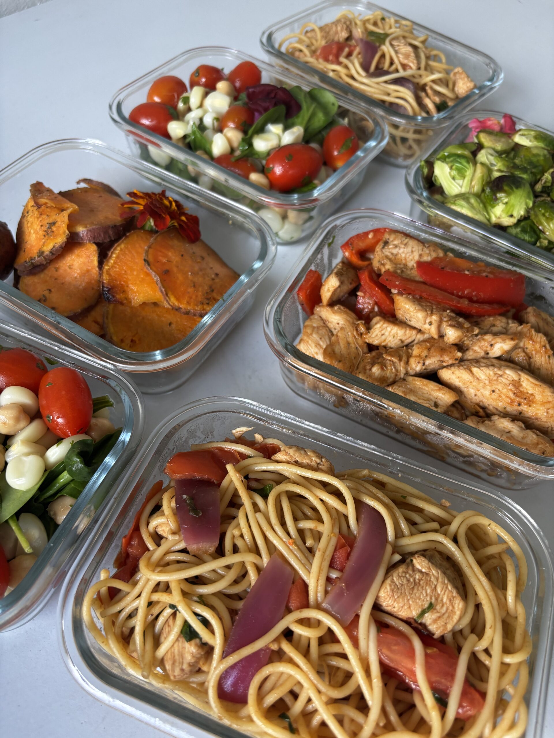 Meal prep containers with healthy food.| ANA MARIA'S CATERING