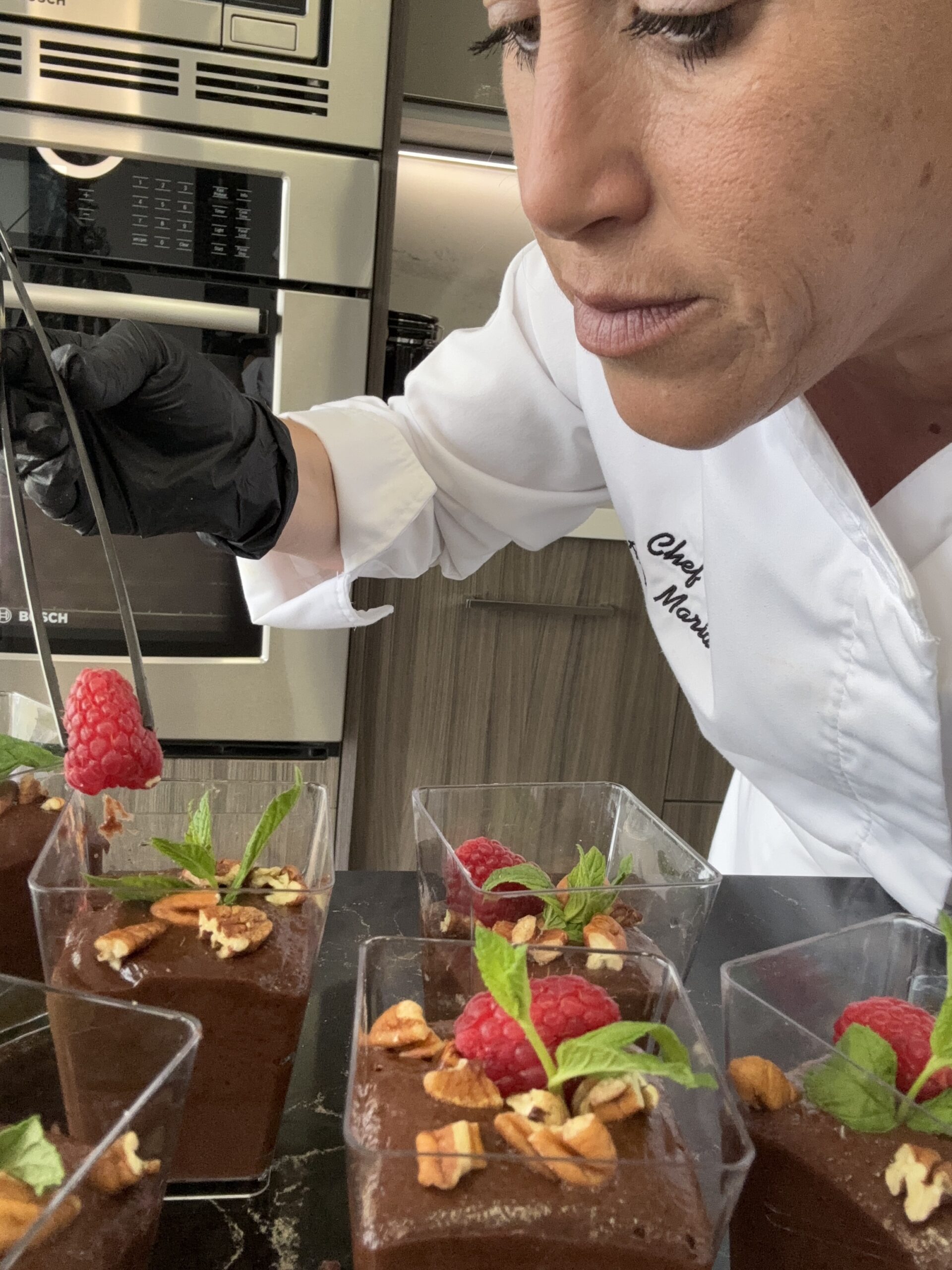 Chef plating chocolate mousse desserts | ANA MARIA'S CATERING
