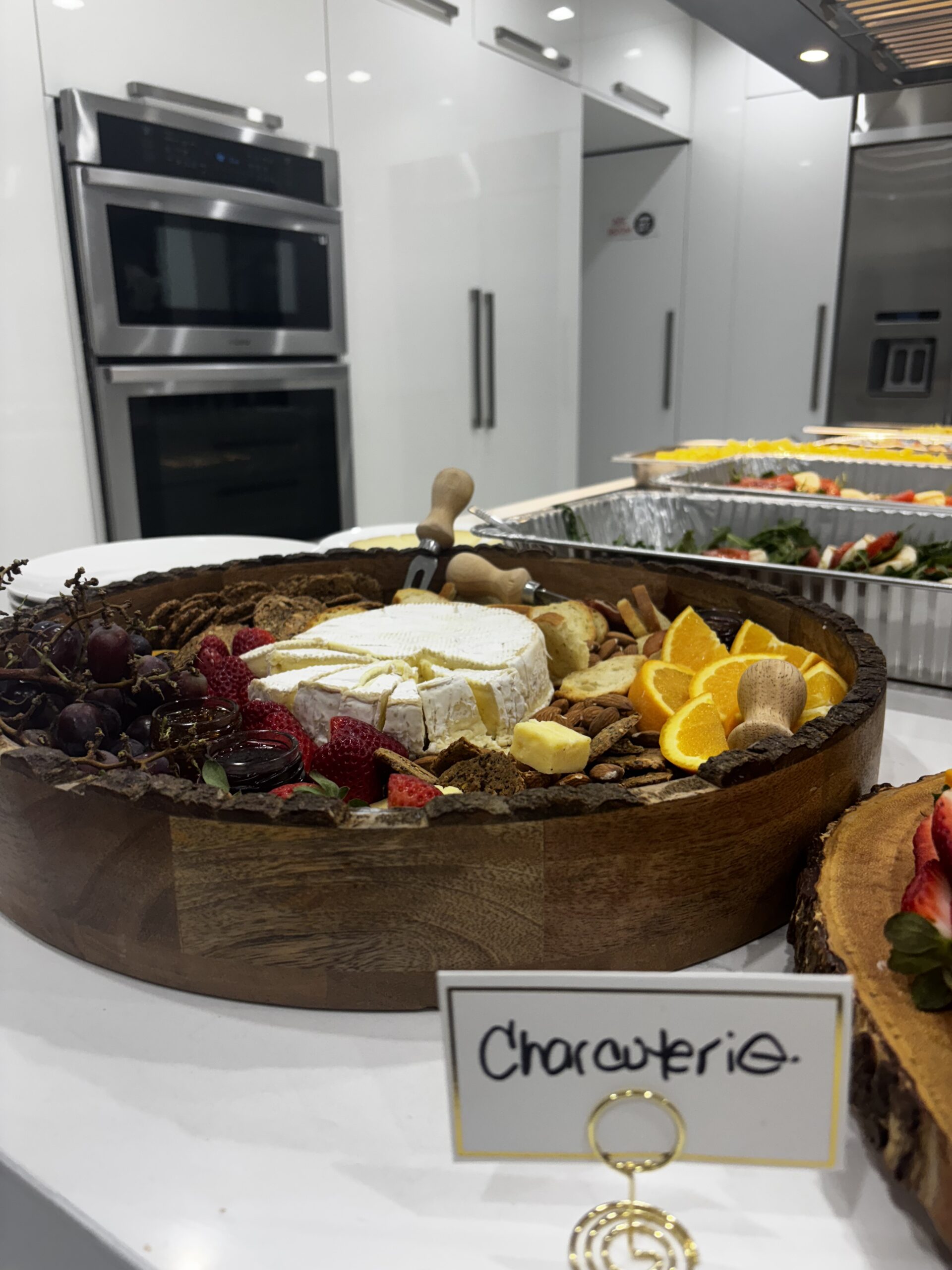 Charcuterie board with cheese and fruit.| ANA MARIA'S CATERING