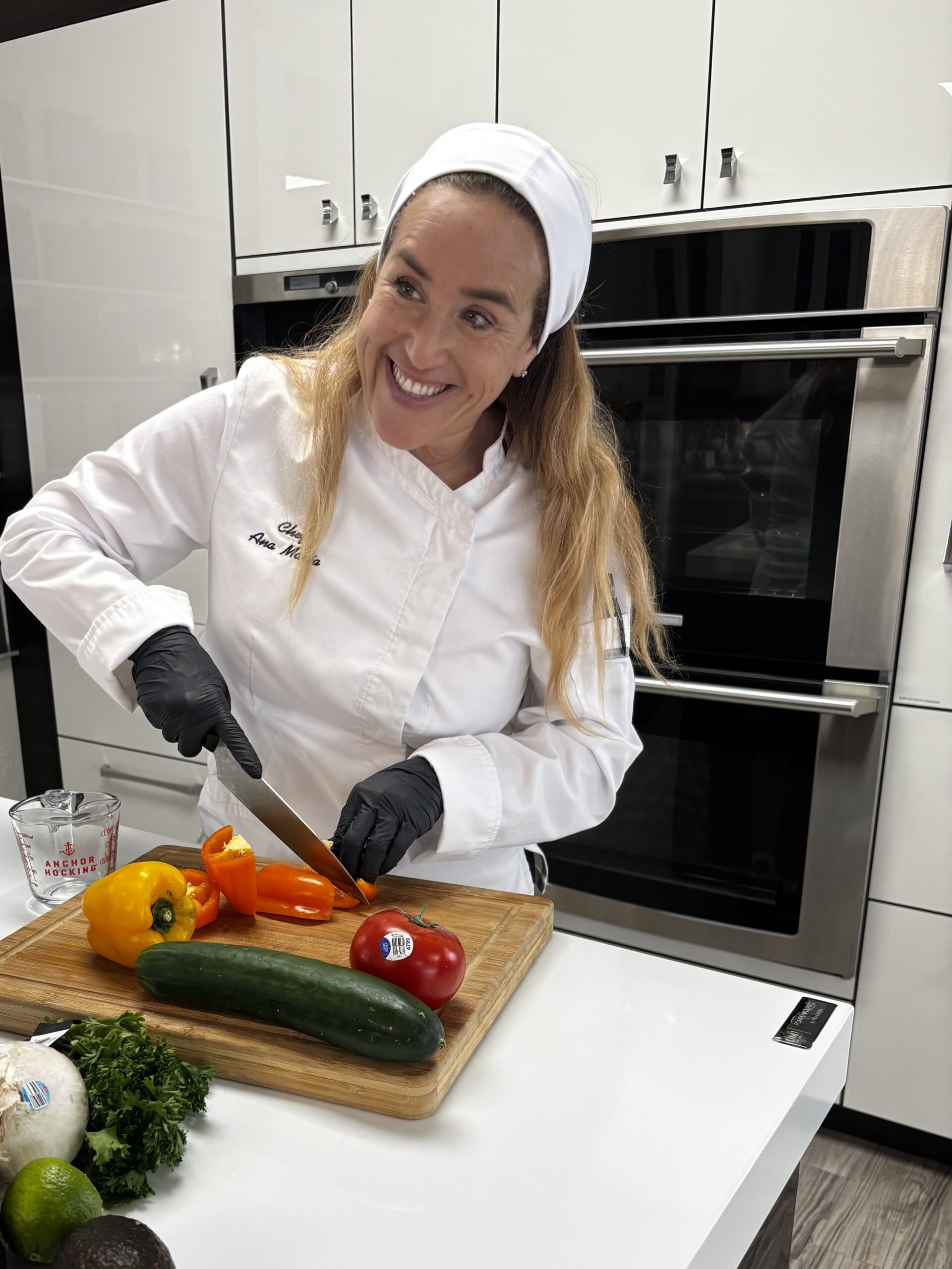 Female chef chopping vegetables in kitchen | ANA MARIA'S CATERING
