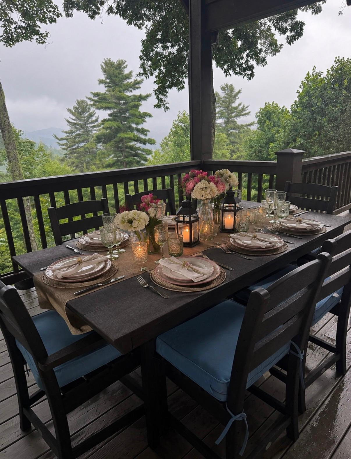 Elegant outdoor dining table set for guests overlooking a forest