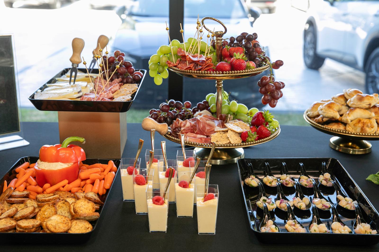 Full grazing table with charcuterie, fruit and dessert cups