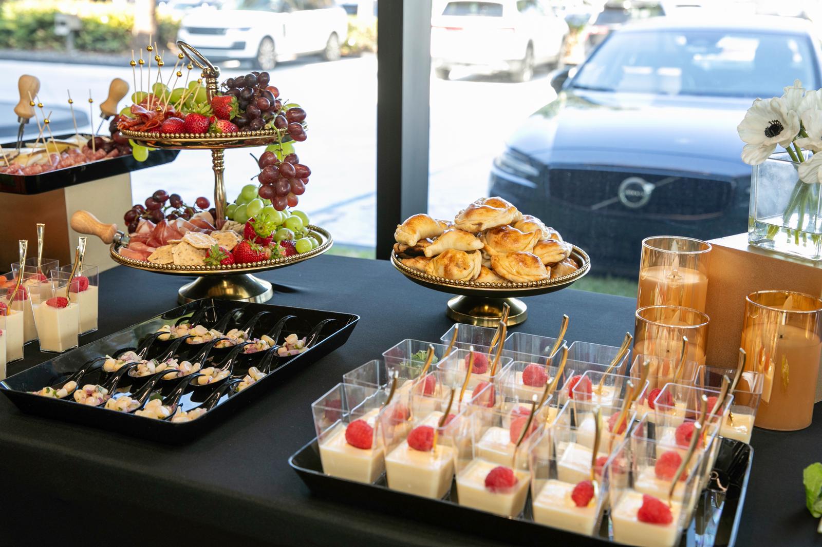 Event buffet with tiered fruit stand, empanadas and candles