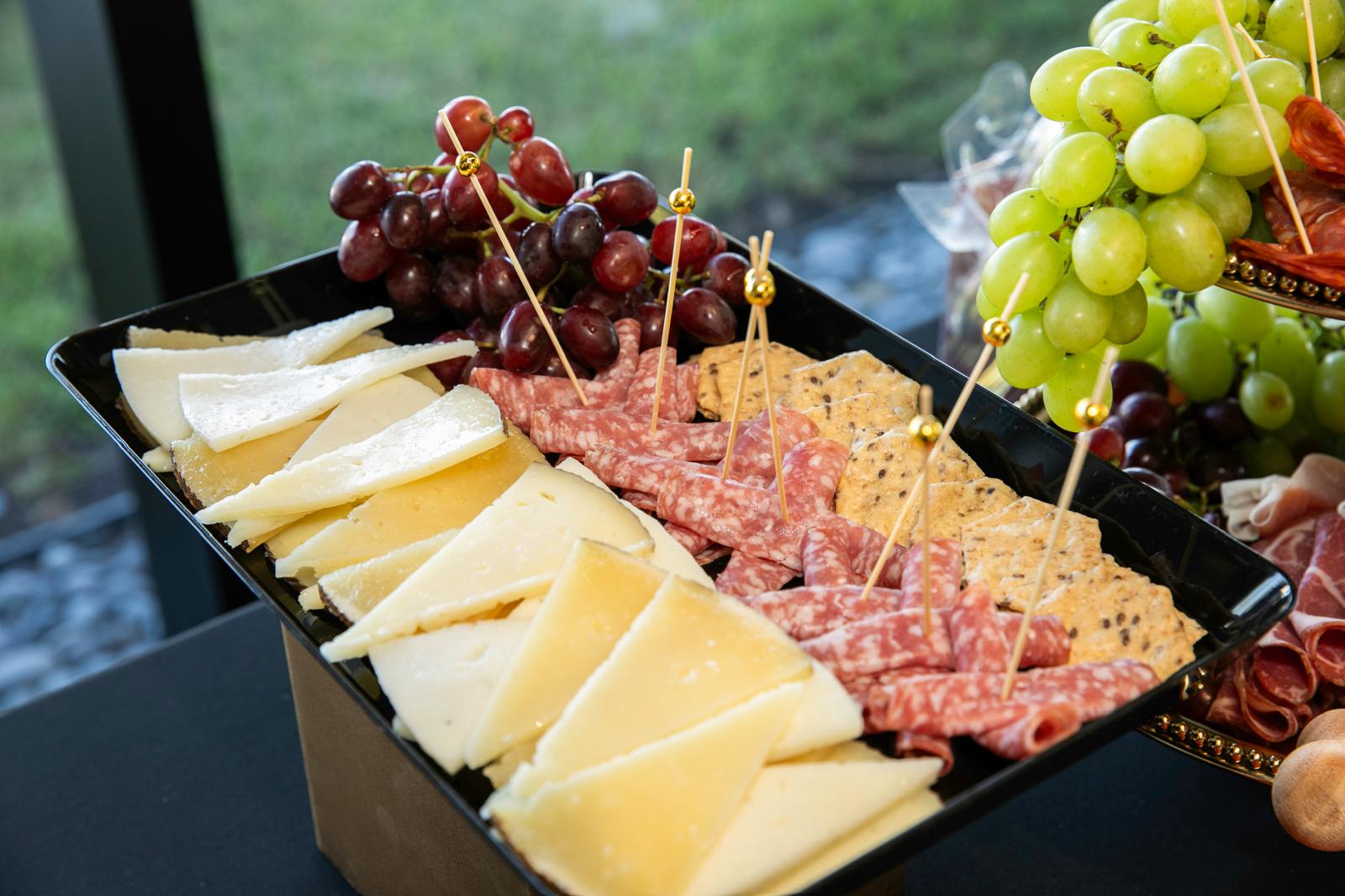Artisan cheese and cured meat platter with grapes