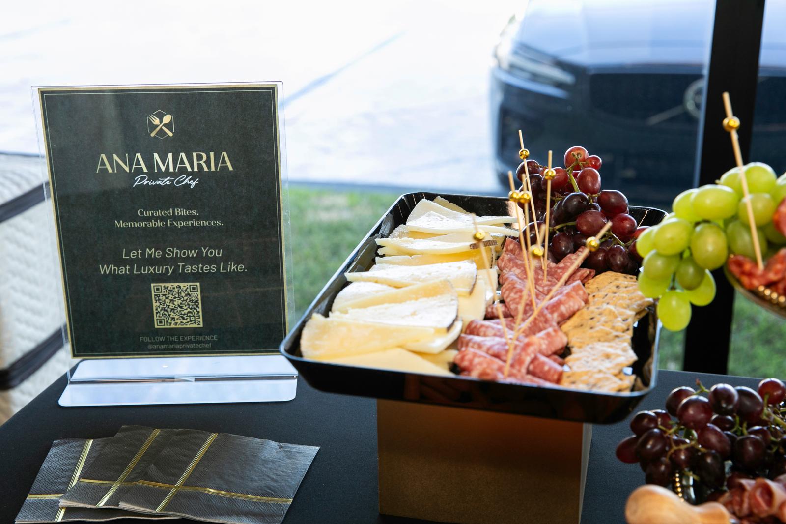 Ana Maria Private Chef signage beside a cheese and charcuterie tray