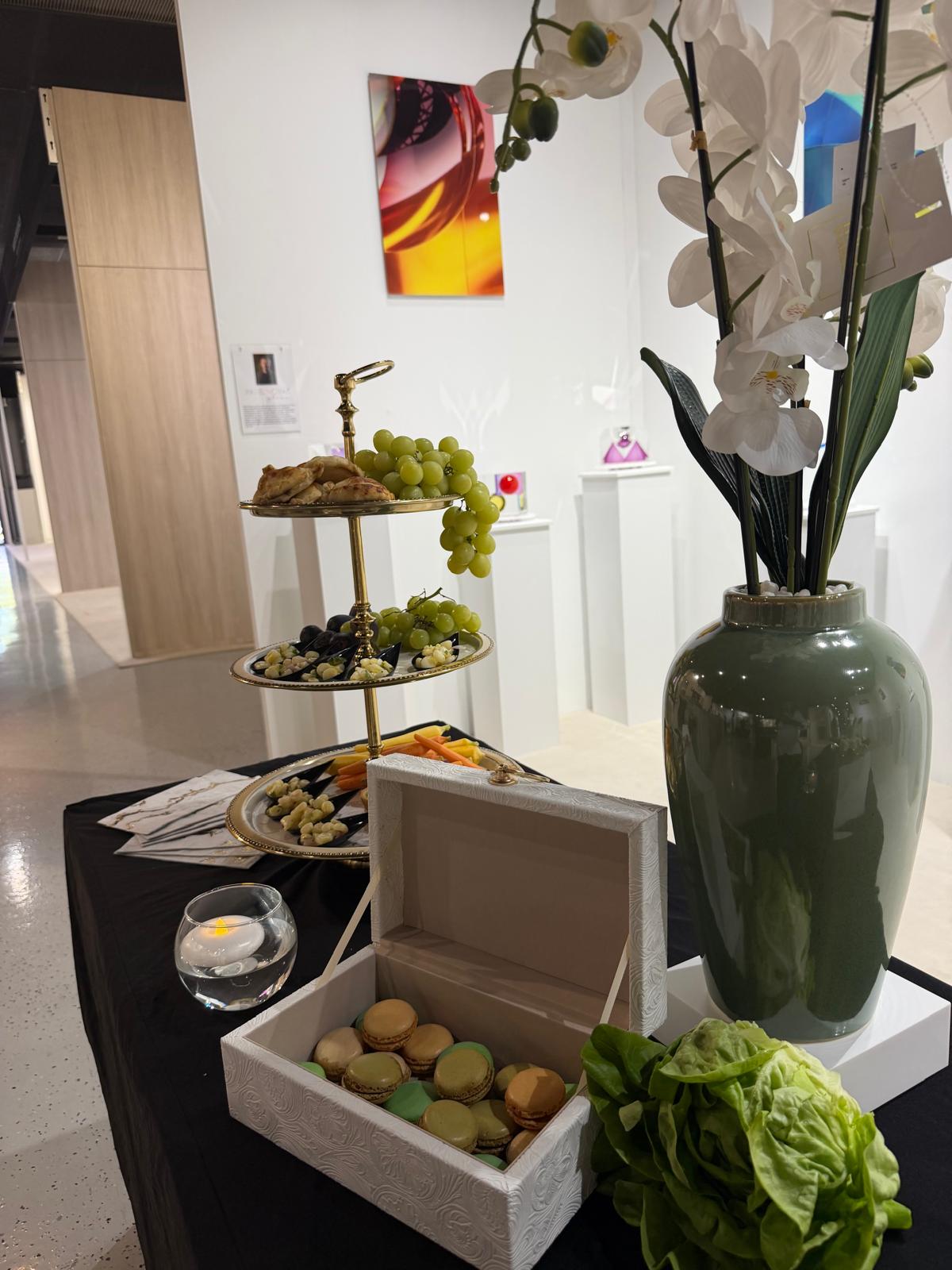 Elegant event table with tiered stand and macarons